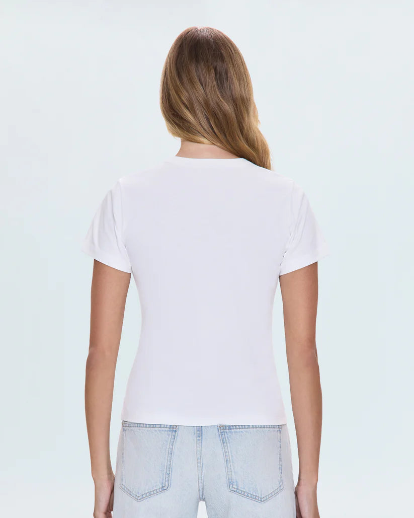 Person wearing a plain white t-shirt and light blue jeans on a light gray background