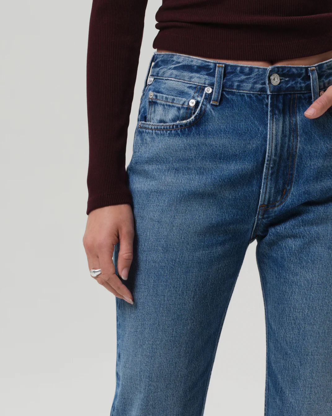 Close up of a model wearing the Citizens of Humanity Zurie Straight Leg Jeans in Demi on a white background.