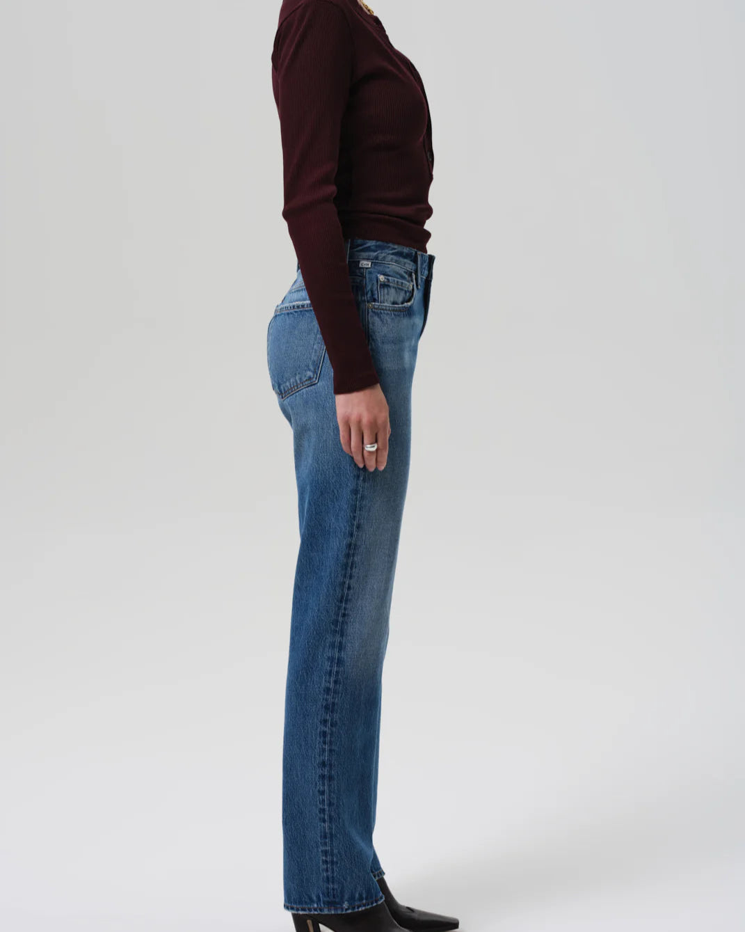Side view of a Model wearing the Citizens of Humanity Zurie Straight Leg Jeans in Demi on a white background.
