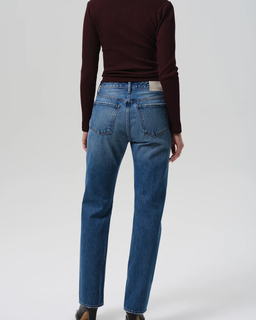 Back view of a model wearing the Citizens of Humanity Zurie Straight Leg Jeans in Demi on a white background.