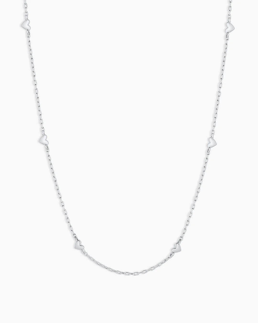 Silver necklace with star-shaped links on a white background