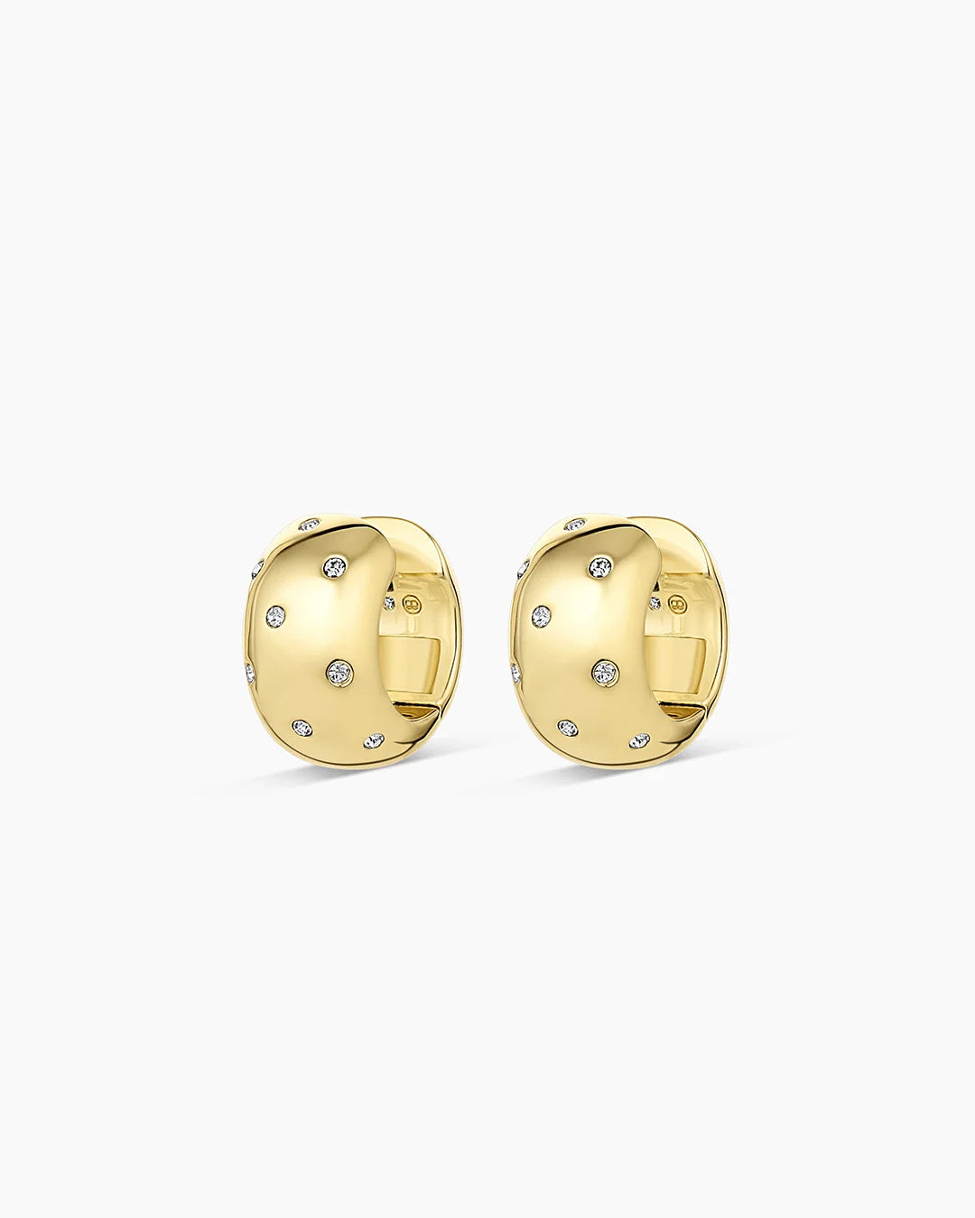 A pair of gold huggie hoop earrings with small clear pavé-set stones, shown on a clean white background.