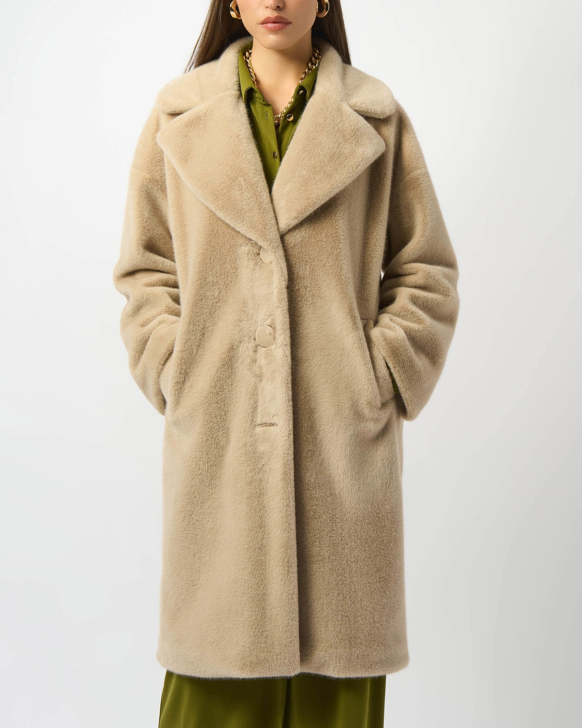 Woman wearing a beige coat on a white background