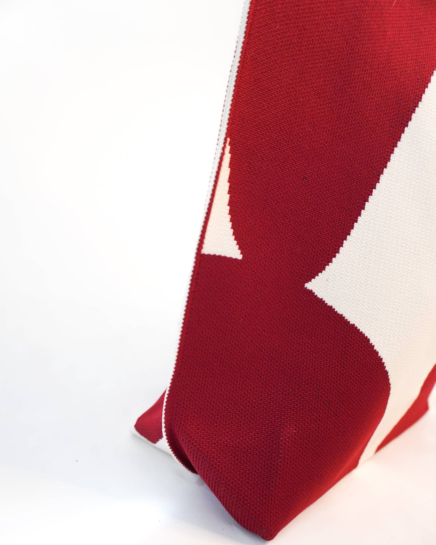 Red and white patterned fabric on a white background