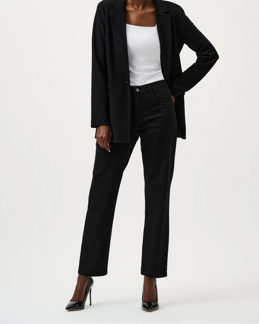 Person wearing a black suit with a white top on a white background