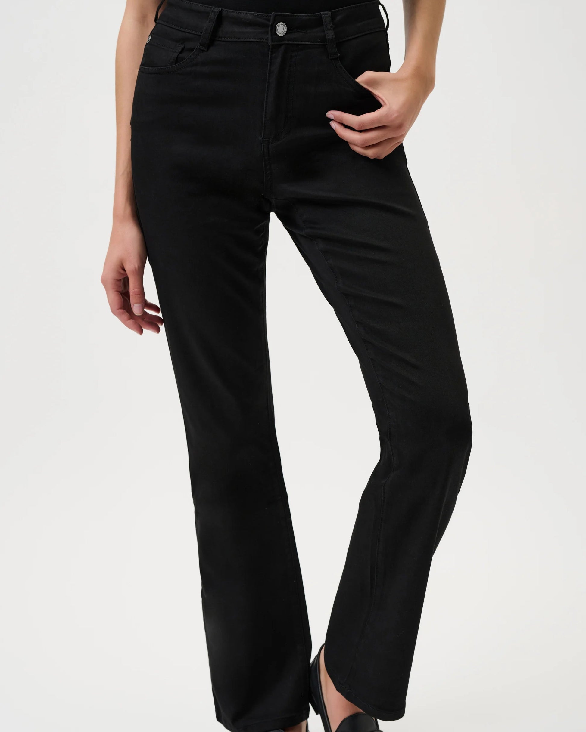 Person wearing black pants on a white background