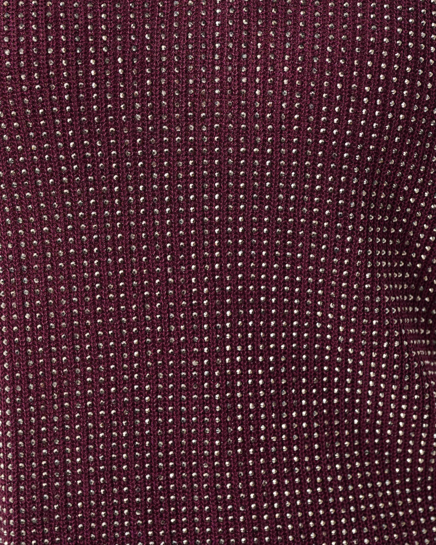Close-up of a textured burgundy fabric with a subtle pattern