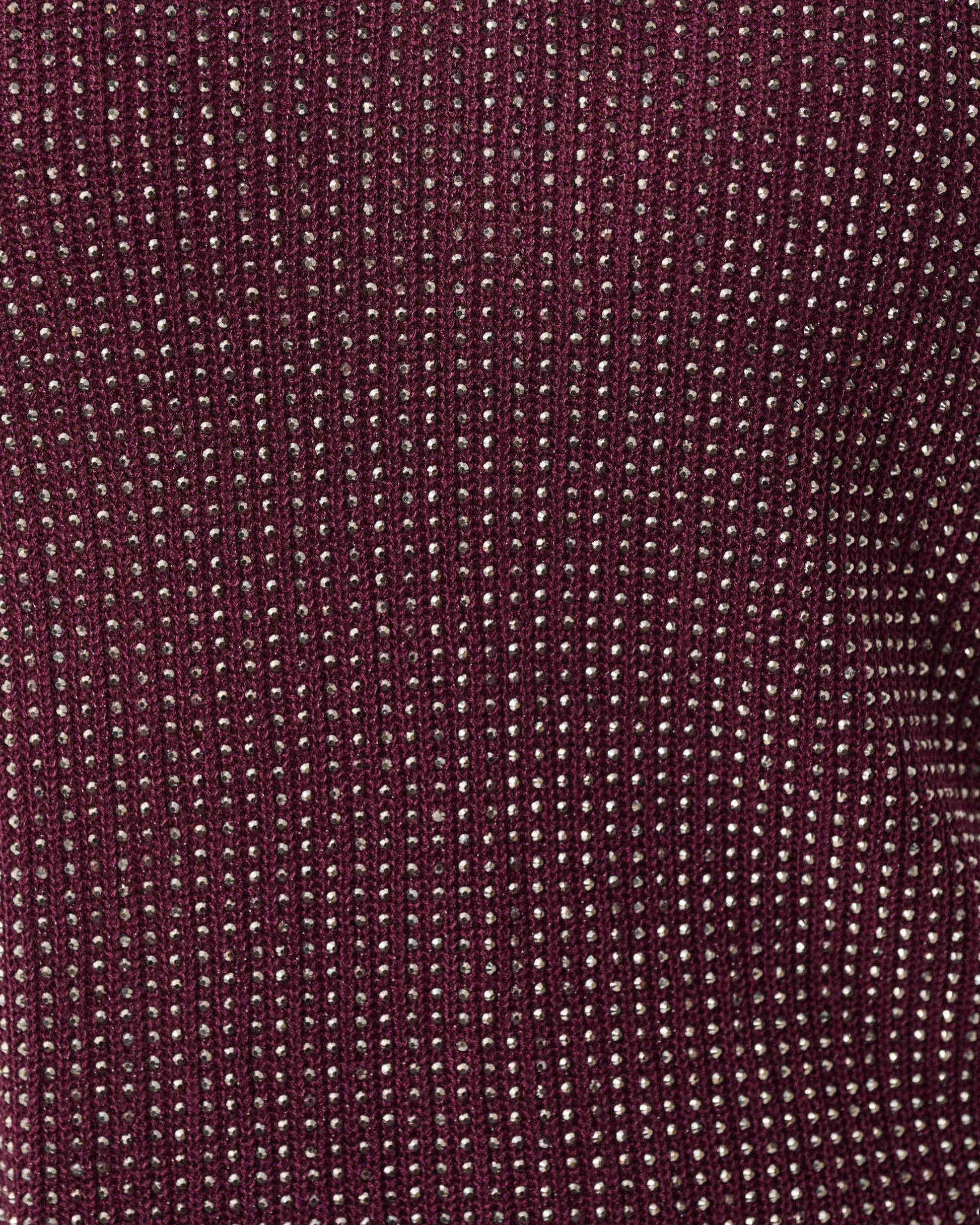 Close-up of a textured burgundy fabric with a subtle pattern