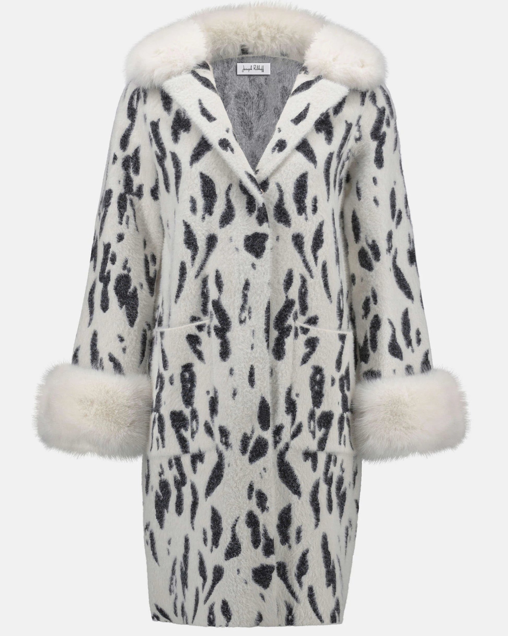 White coat with black pattern and fur trim on a white background