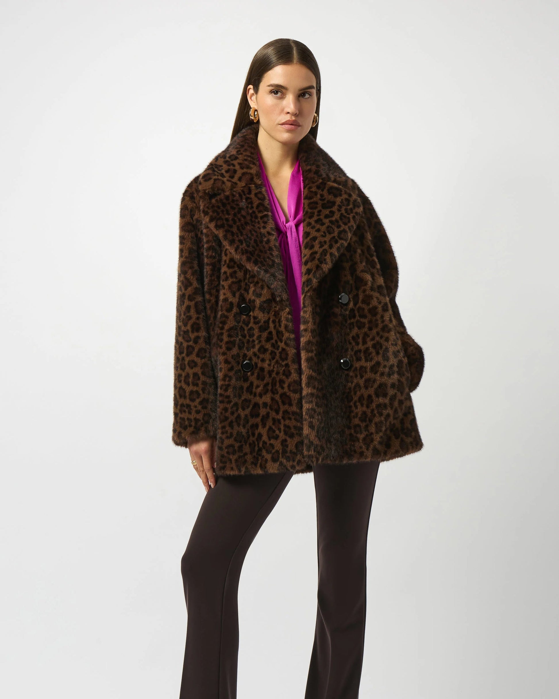Woman wearing a leopard print coat on a white background