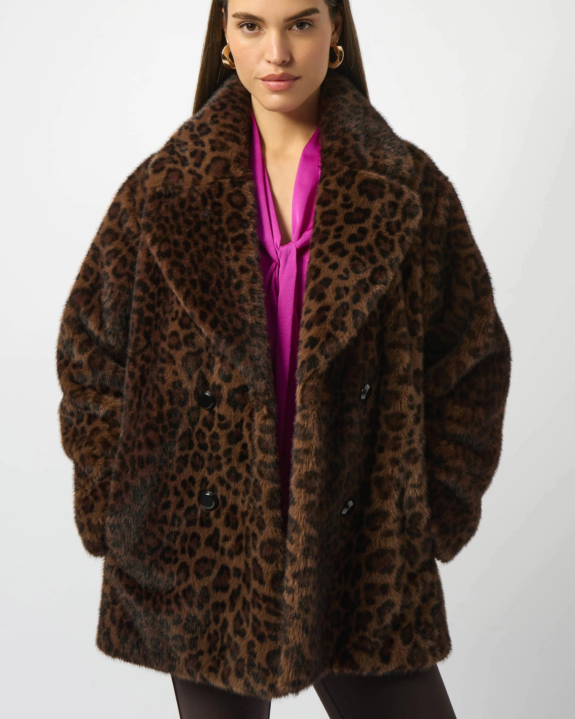 Woman wearing a leopard print coat on a white background