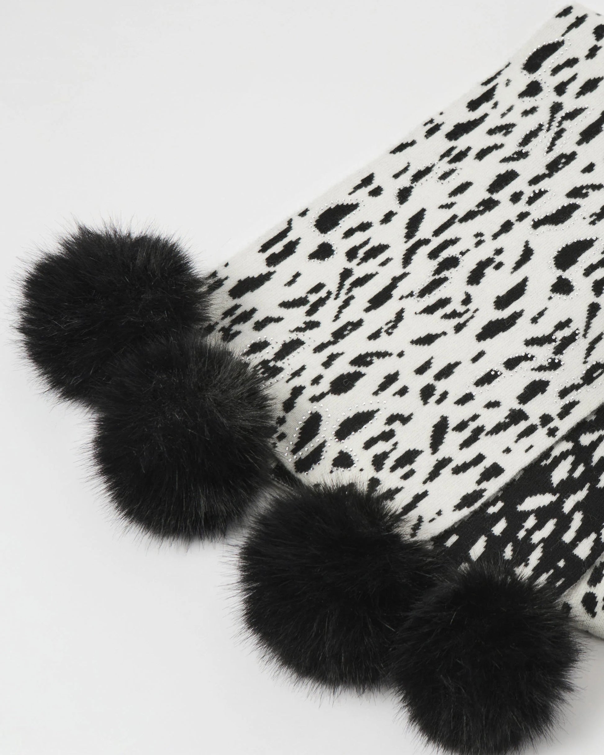 Black fur pom-poms on a white background