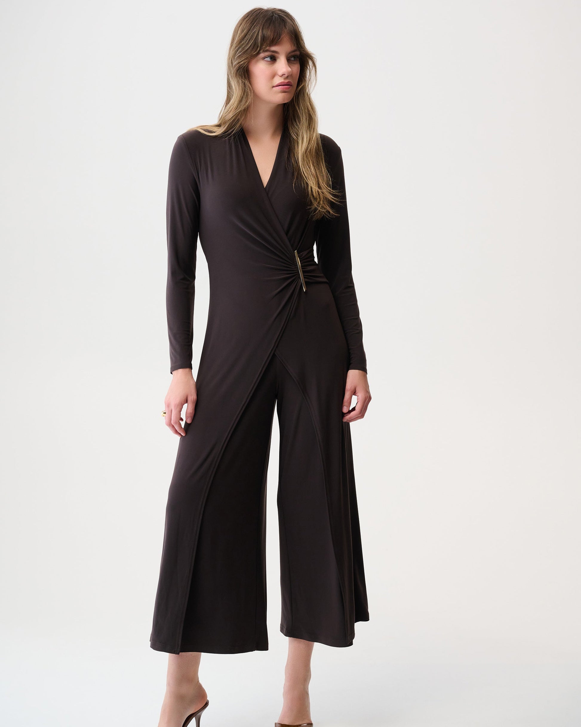 Woman wearing a brown jumpsuit on a white background