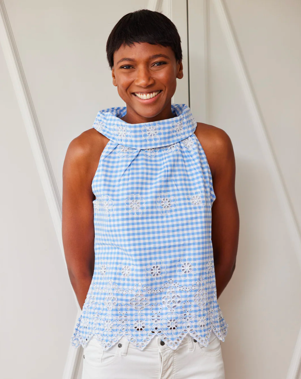 Model wearing Sail to Sable Gingham Button Back Top in blue wearing white jeans on a white background