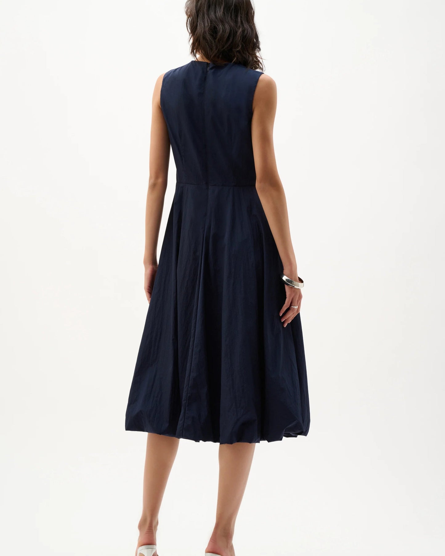 Woman wearing a navy blue dress on a white background