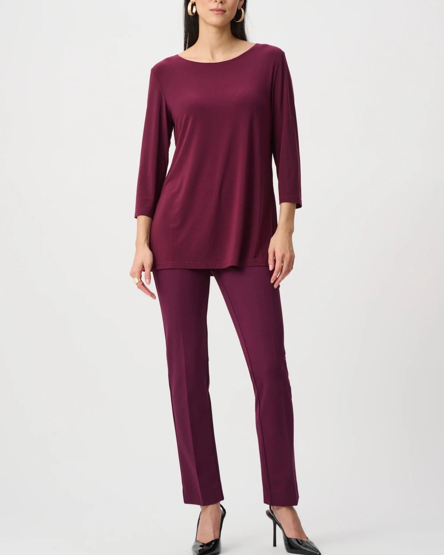 Woman wearing a burgundy outfit on a white background