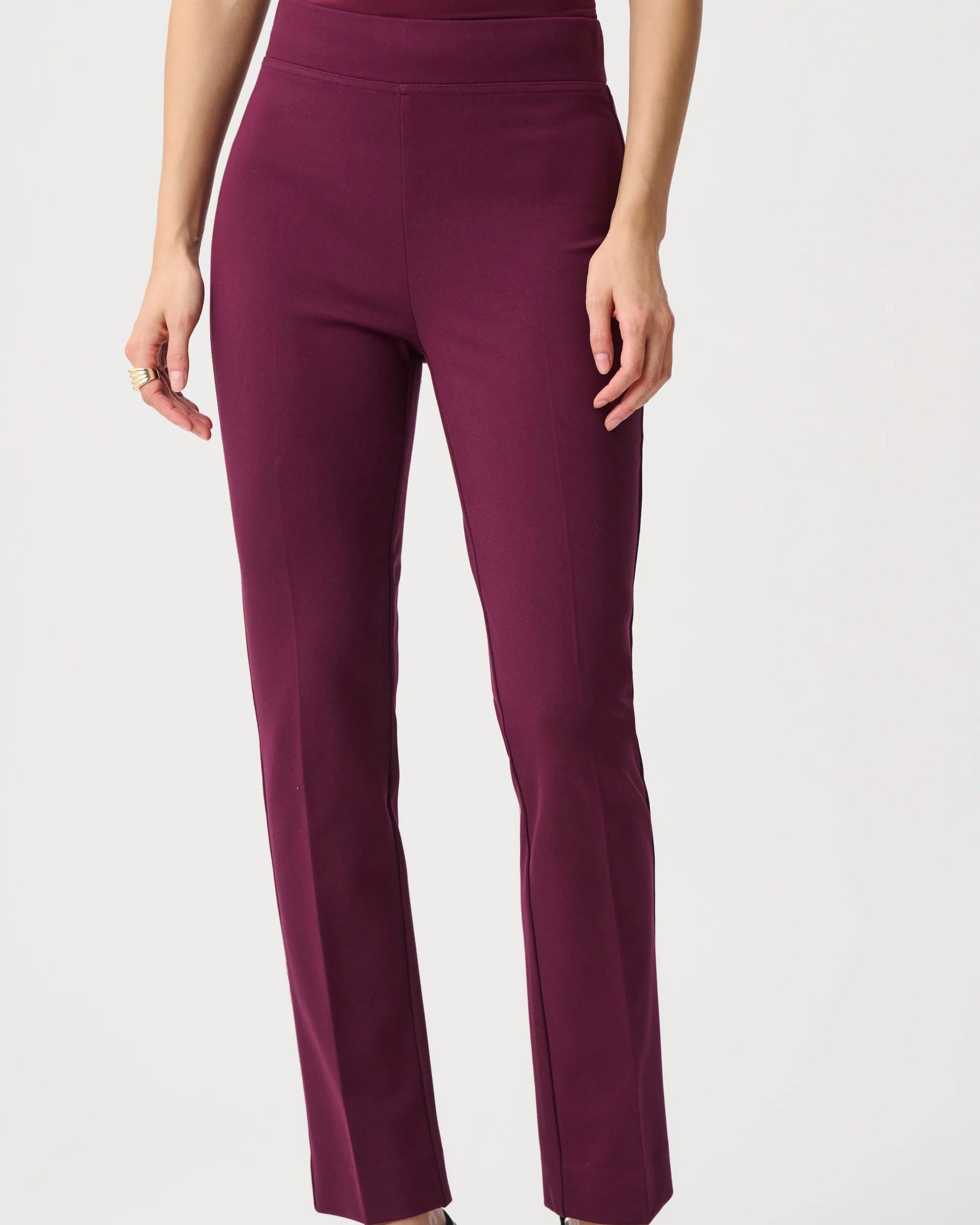 Purple pants worn by a person on a white background