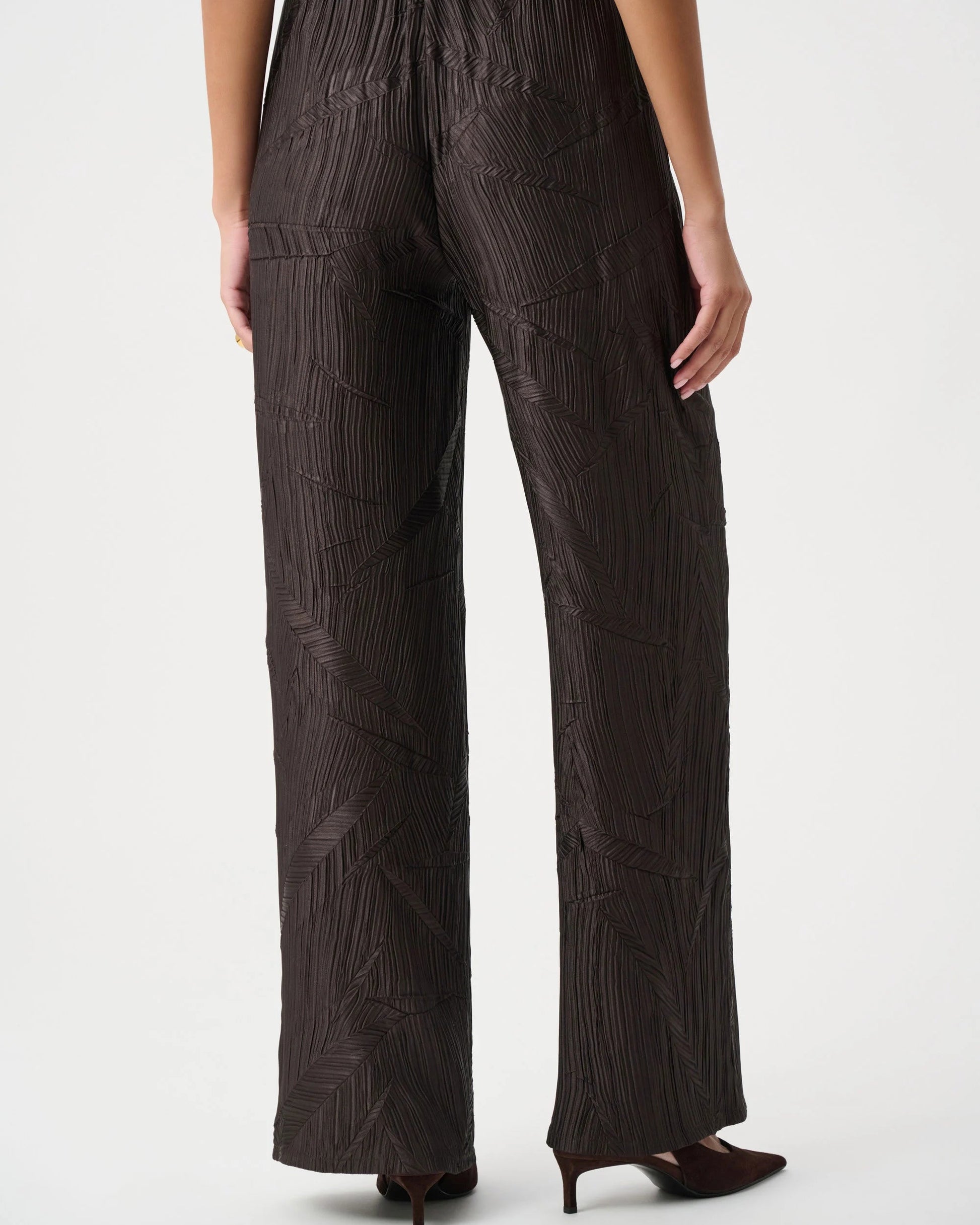 Dark brown textured jumpsuit worn by a person on a white background