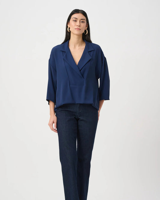 Woman wearing a navy blue suit on a white background