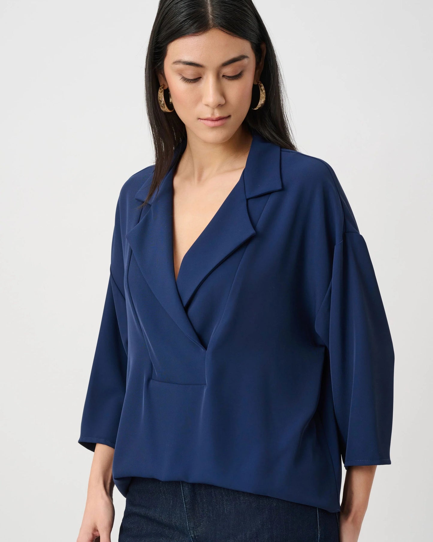 Woman wearing a blue blazer against a white background