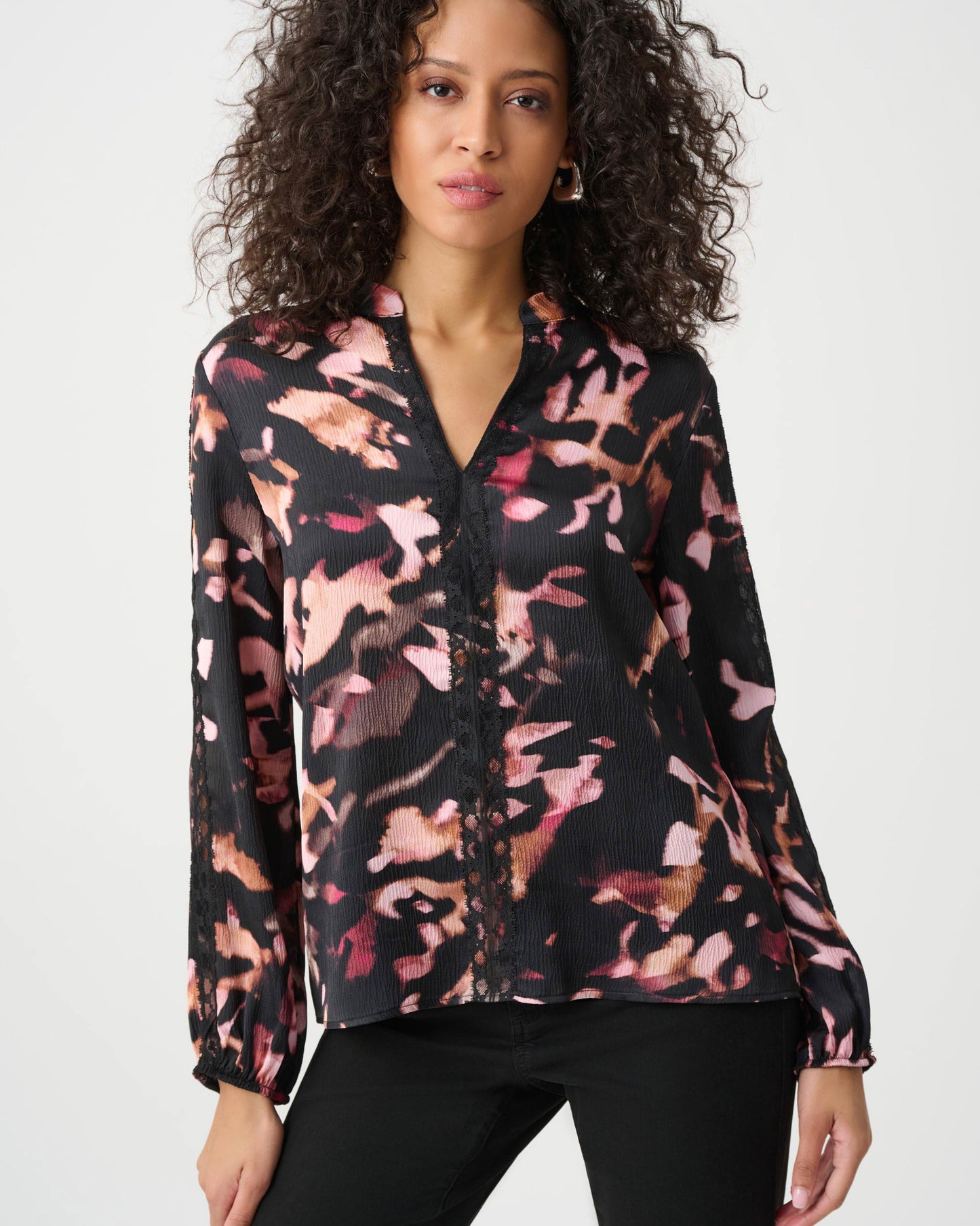 Woman wearing a floral blouse with a white background