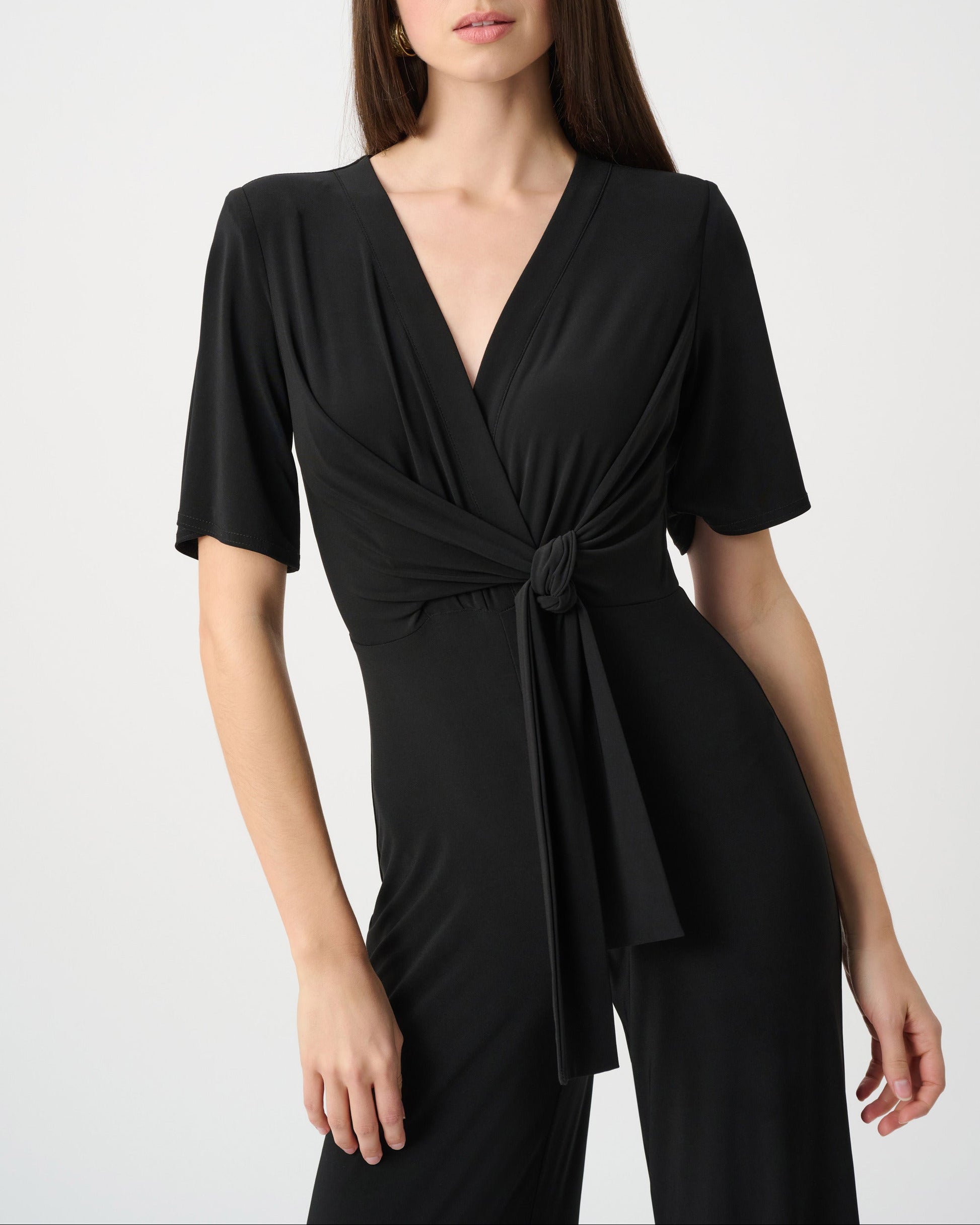 Woman wearing a black dress with a white background