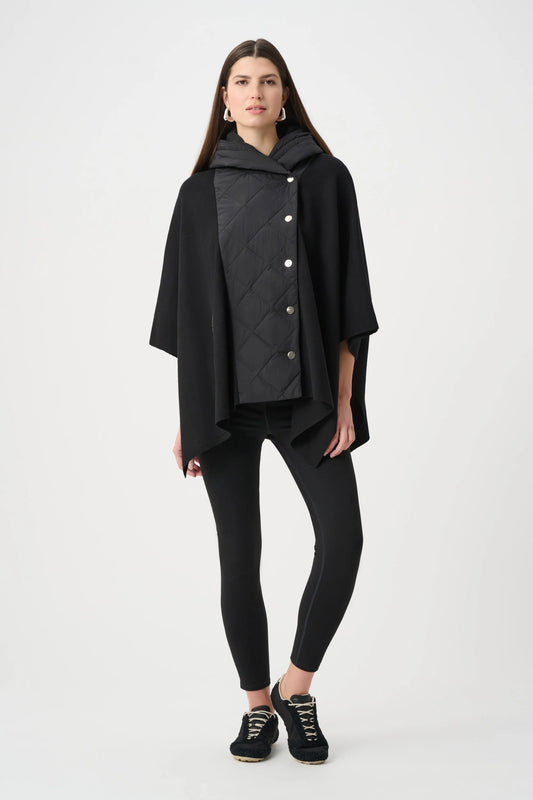 Woman wearing a black quilted poncho on a white background