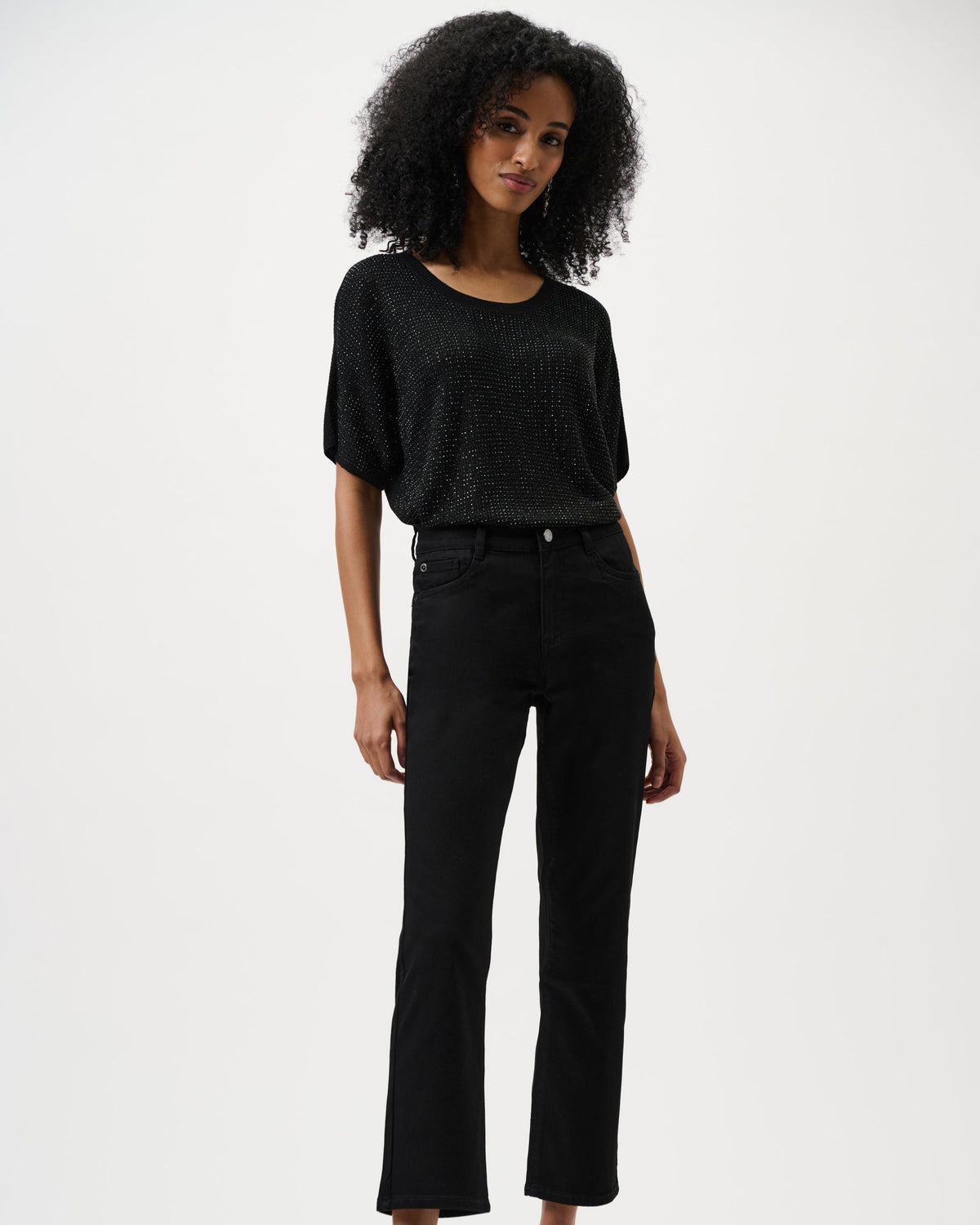 Woman wearing a black outfit on a white background