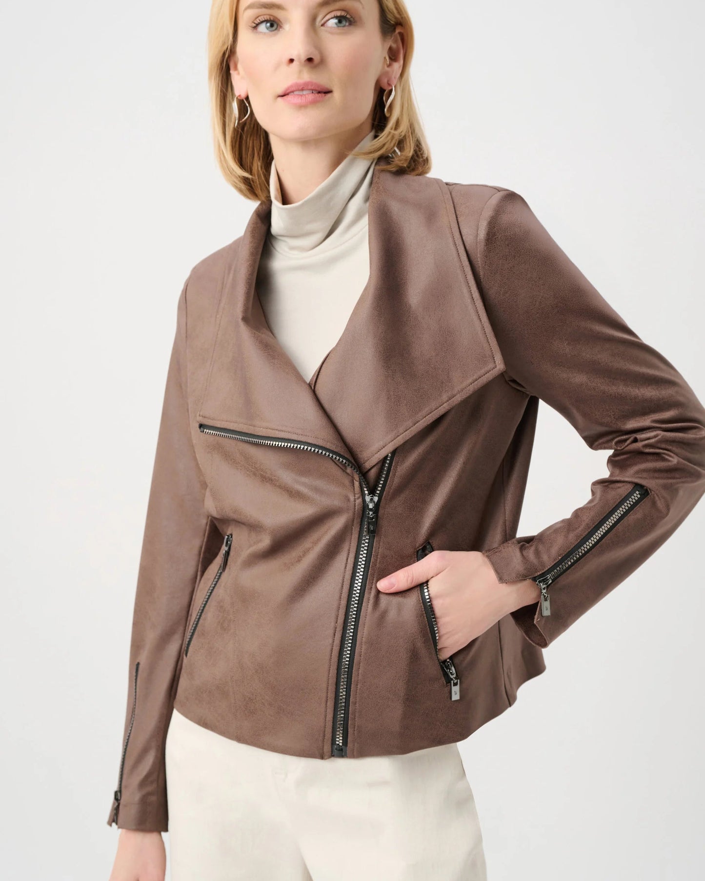 Woman wearing a brown leather jacket on a white background