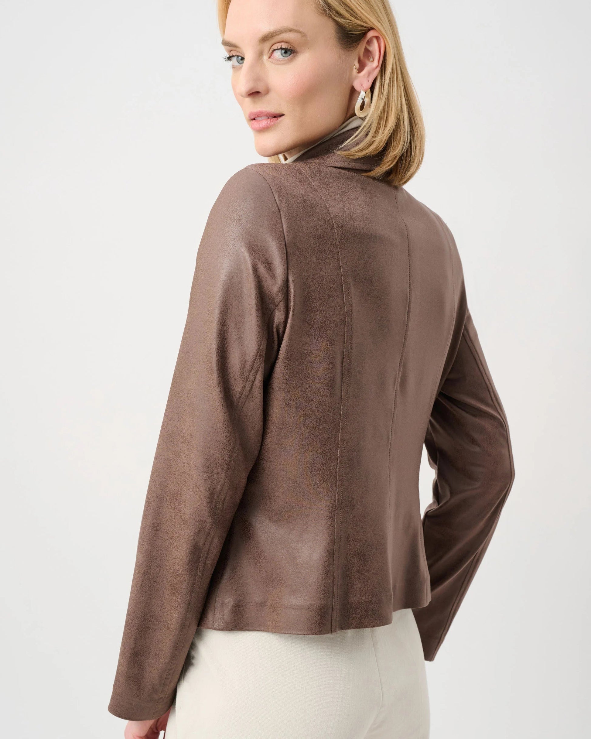 Woman wearing a brown jacket on a white background