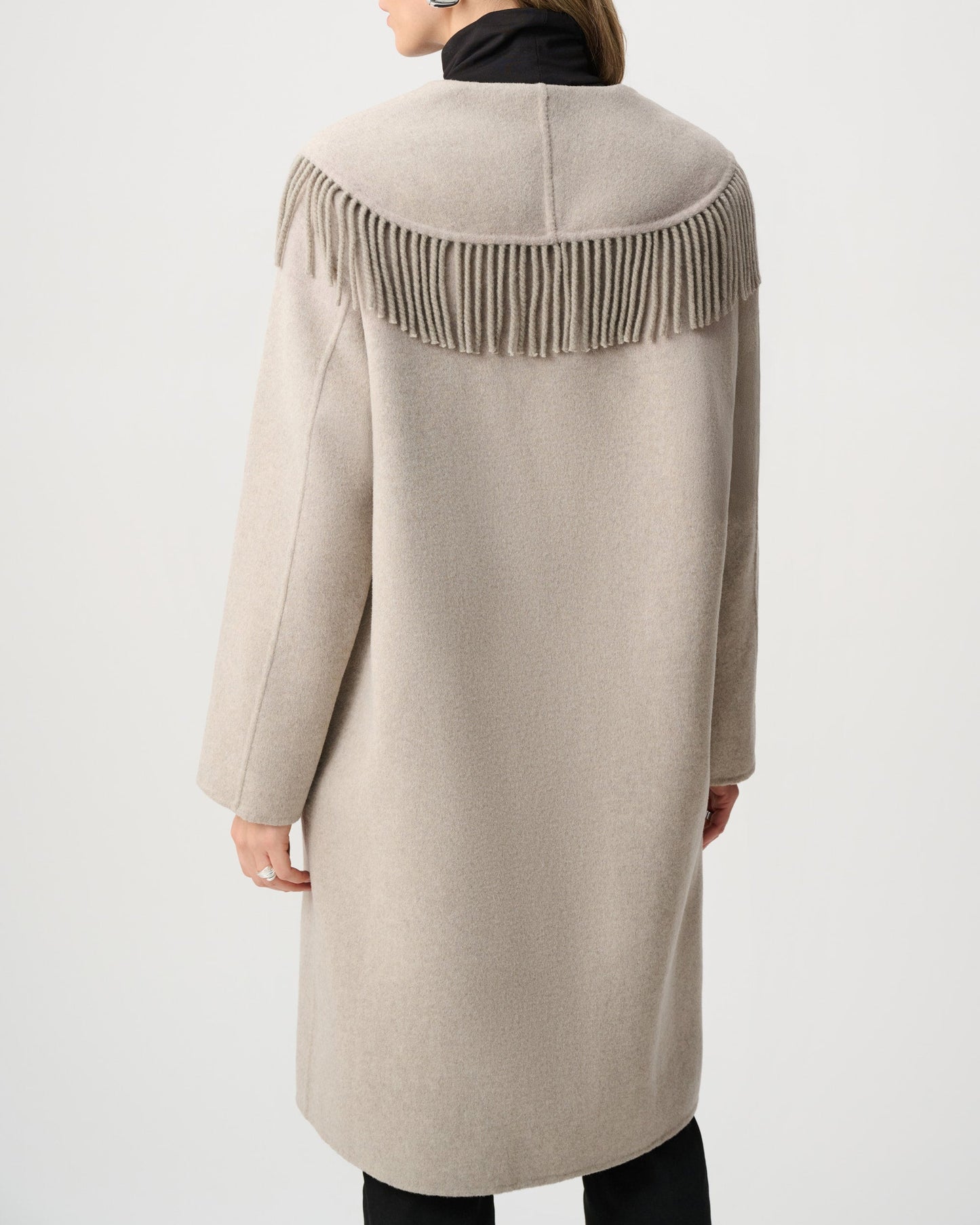 Beige coat with fringe details on a white background