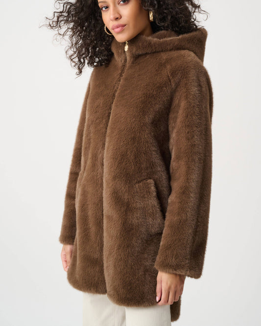 Woman wearing a brown faux fur coat on a white background