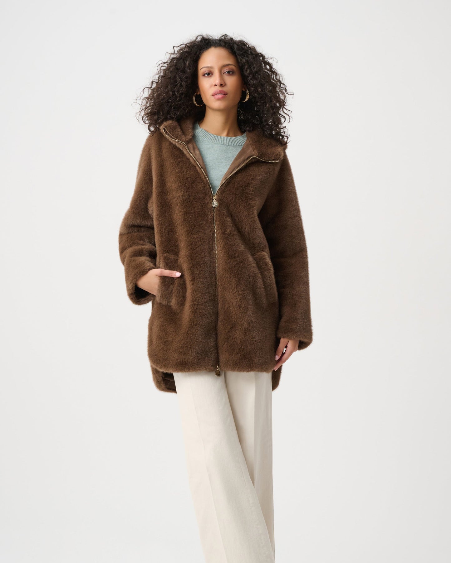 Woman wearing a brown coat on a white background