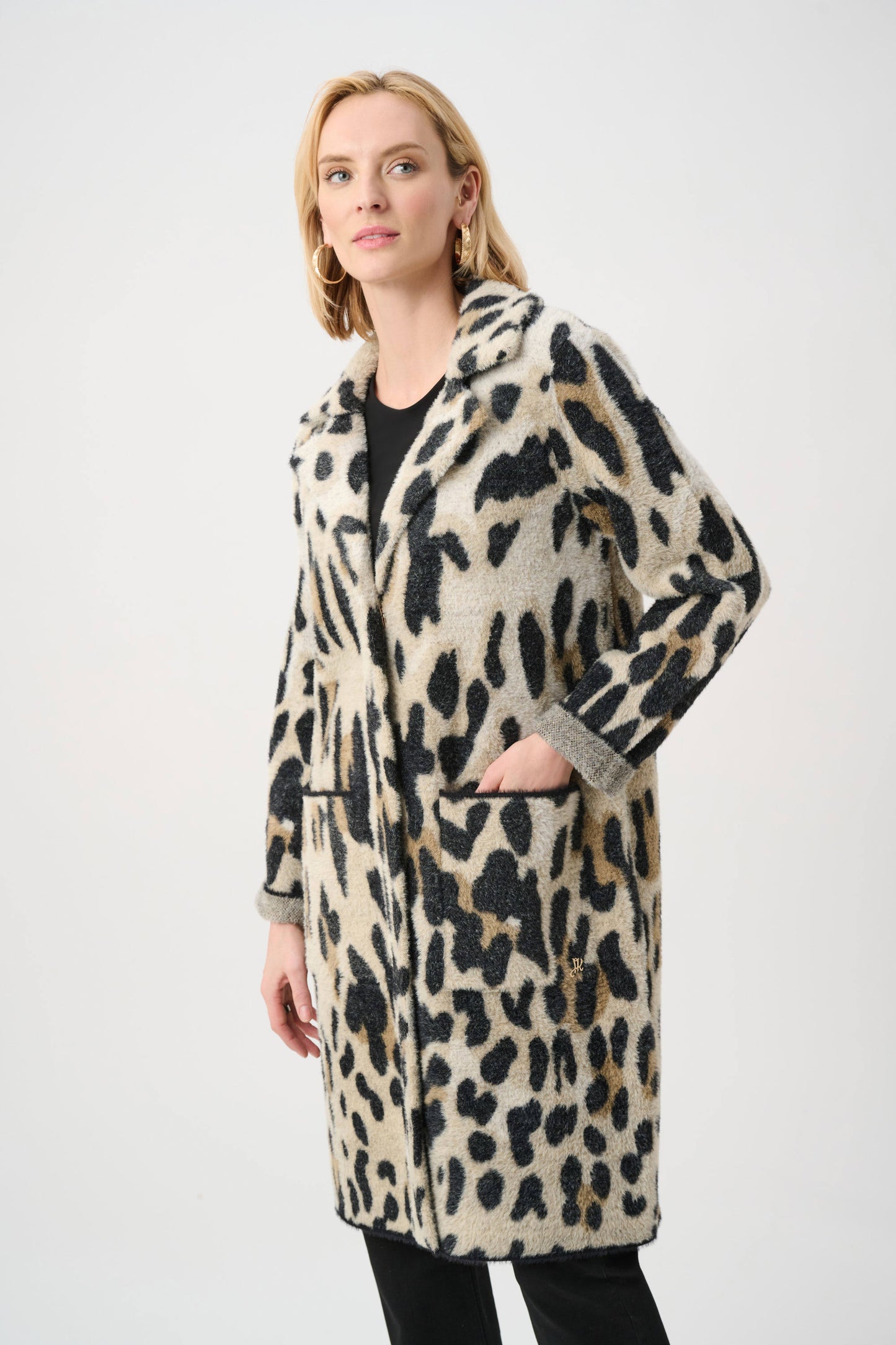 Woman wearing a leopard print coat on a white background