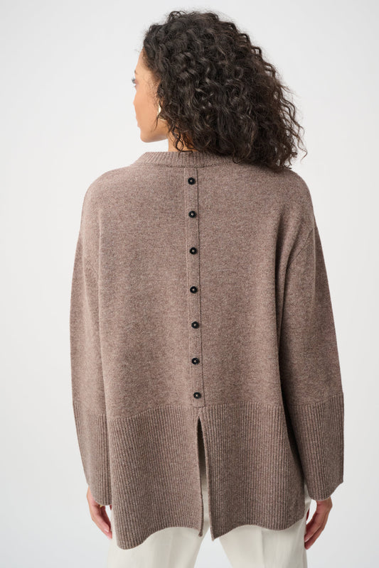 Woman wearing a brown cardigan with buttons on a white background