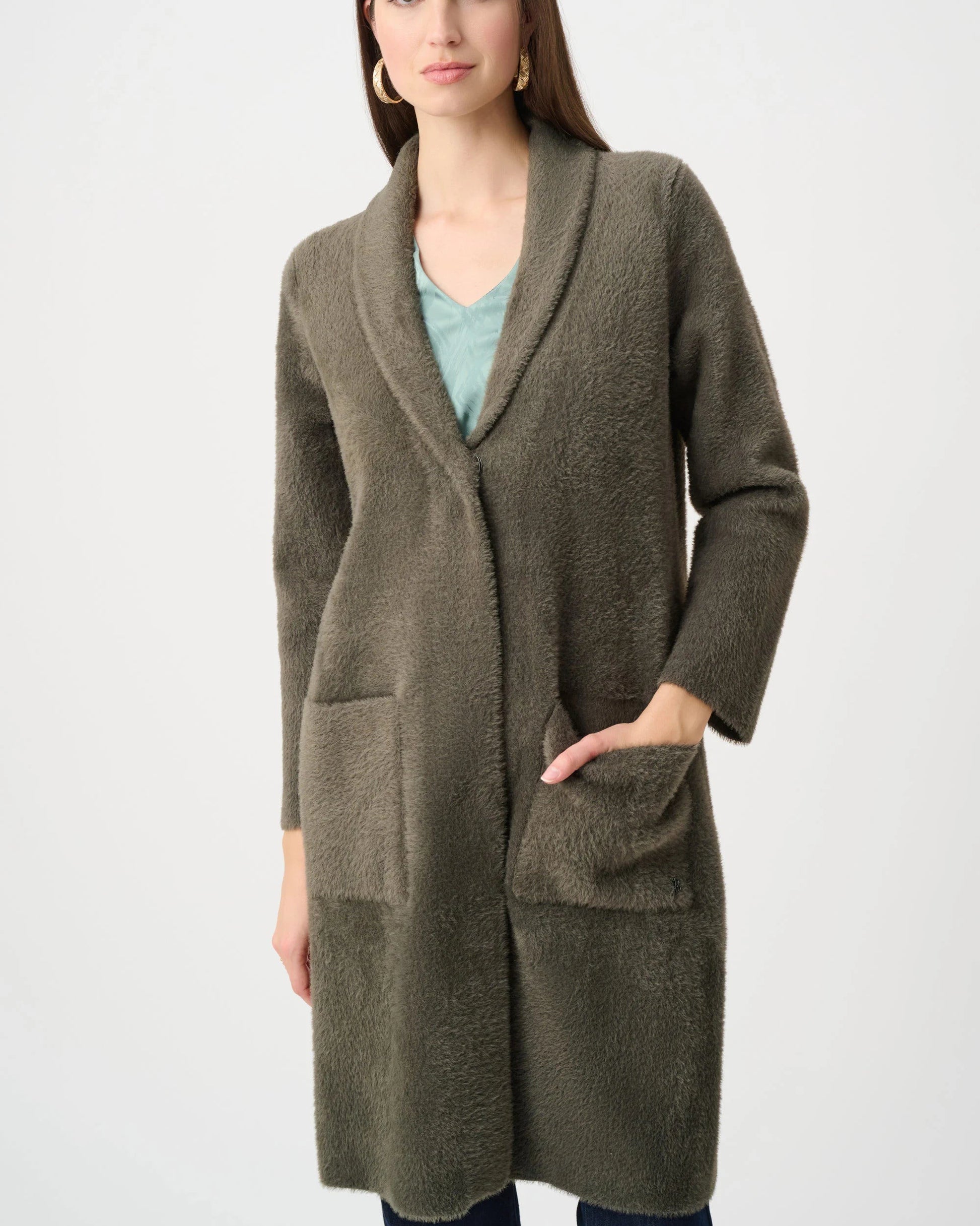 Woman wearing a long brown cardigan on a white background