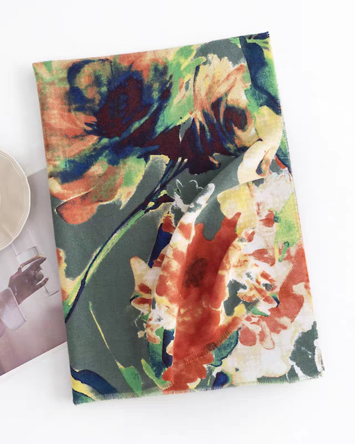Floral-patterned notebook with a cup and magazine on a white background