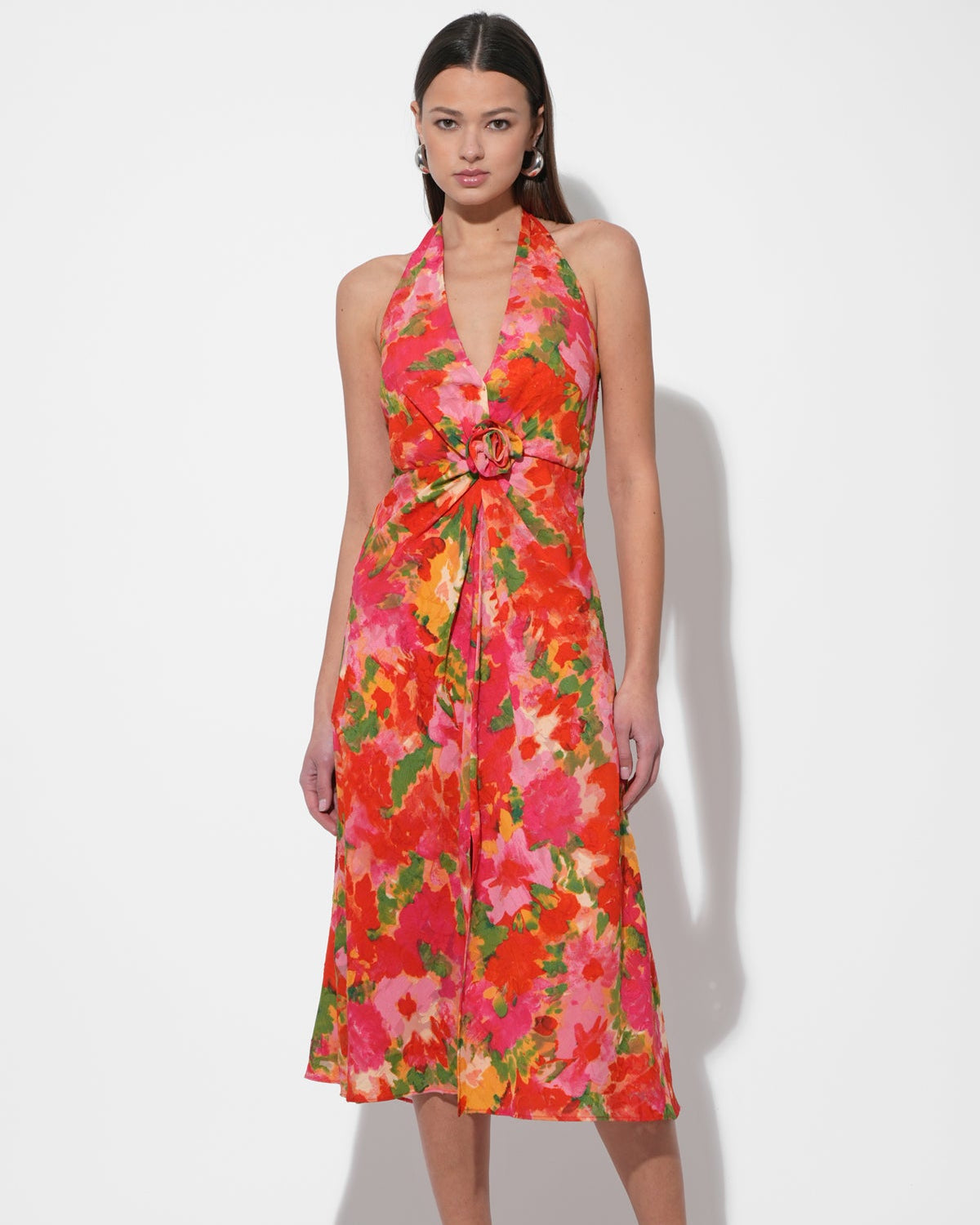 Model in the Hatrina Halter Midi Dress with Rosette in front of a white background.