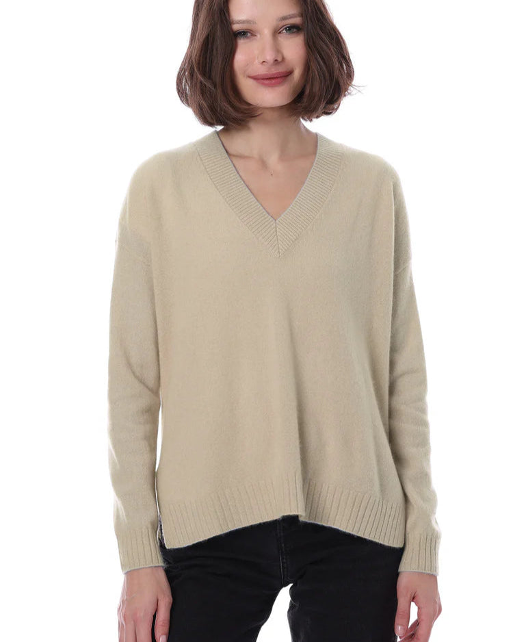 Woman wearing a beige sweater on a white background