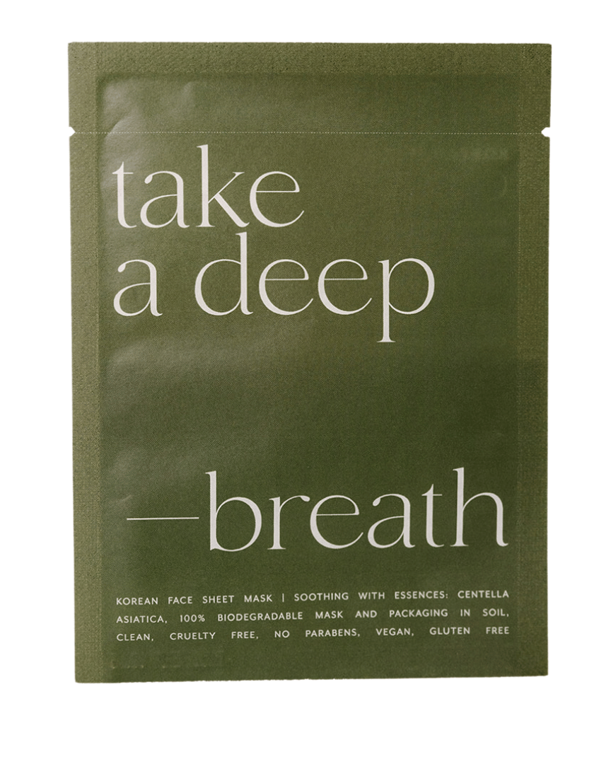 Green face mask packaging with 'take a deep breath' text on a white background