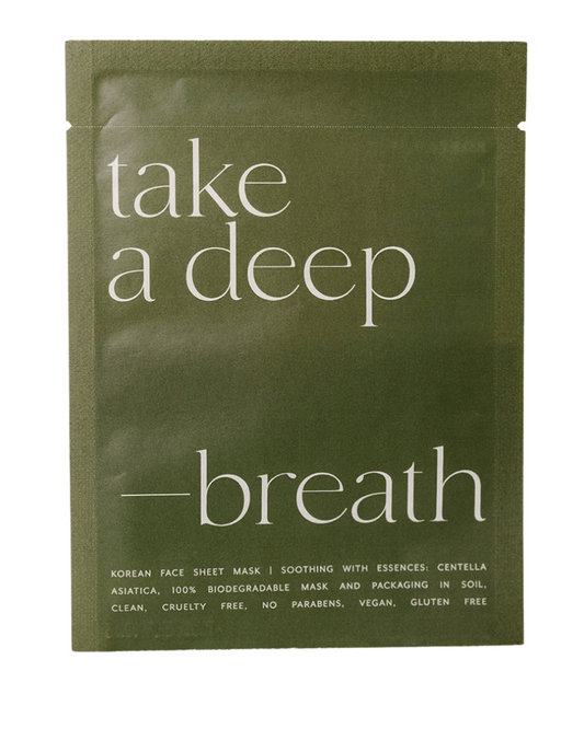 Green face mask packaging with 'take a deep breath' text on a white background