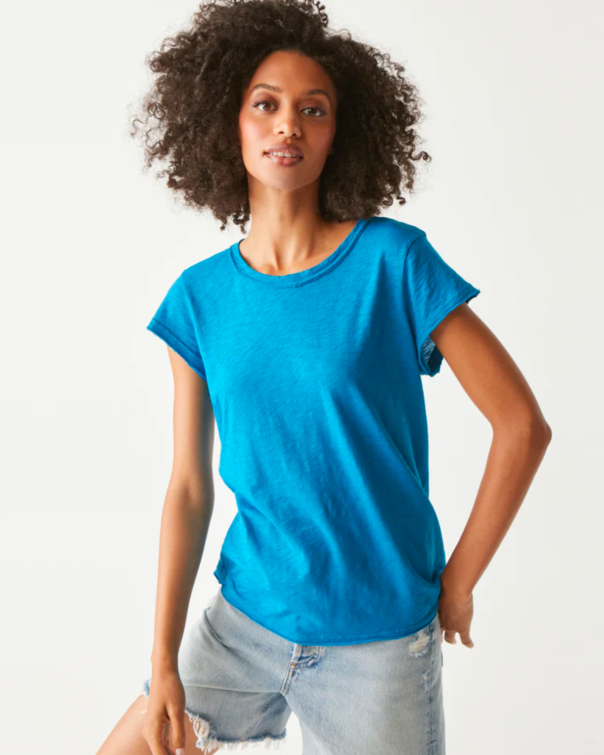 Model wearing a Michael Stars Trudy Crew tee in pacific wearing jeans on a white background