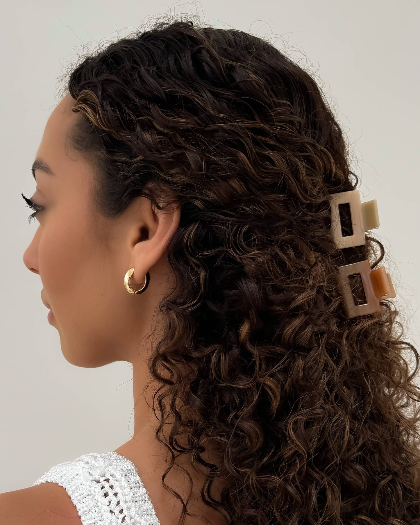 Women wearing the HoneyLux Acetate Mini Square Claws in the color Blonde against a neutral background