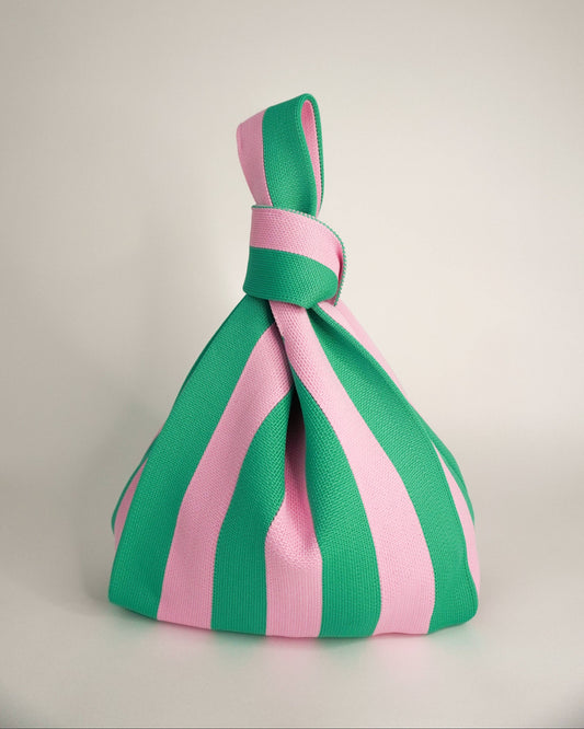 Green and pink striped knot on a light gray background