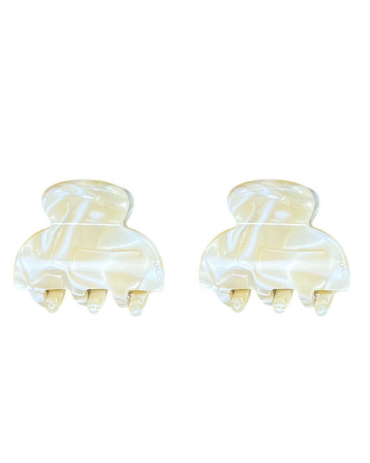 Two marbled hair clamps on a white background