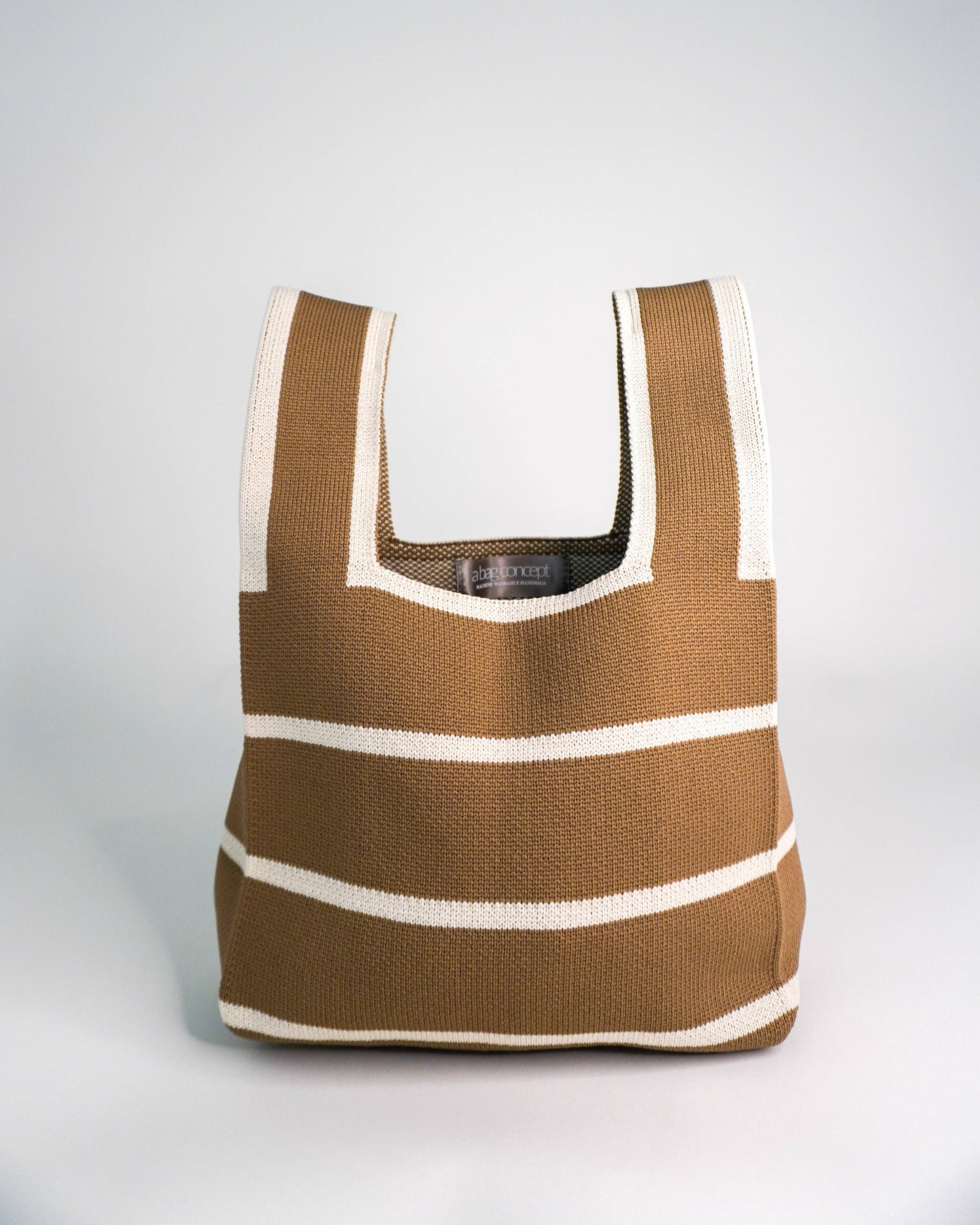 Brown and white striped bag on a light gray background