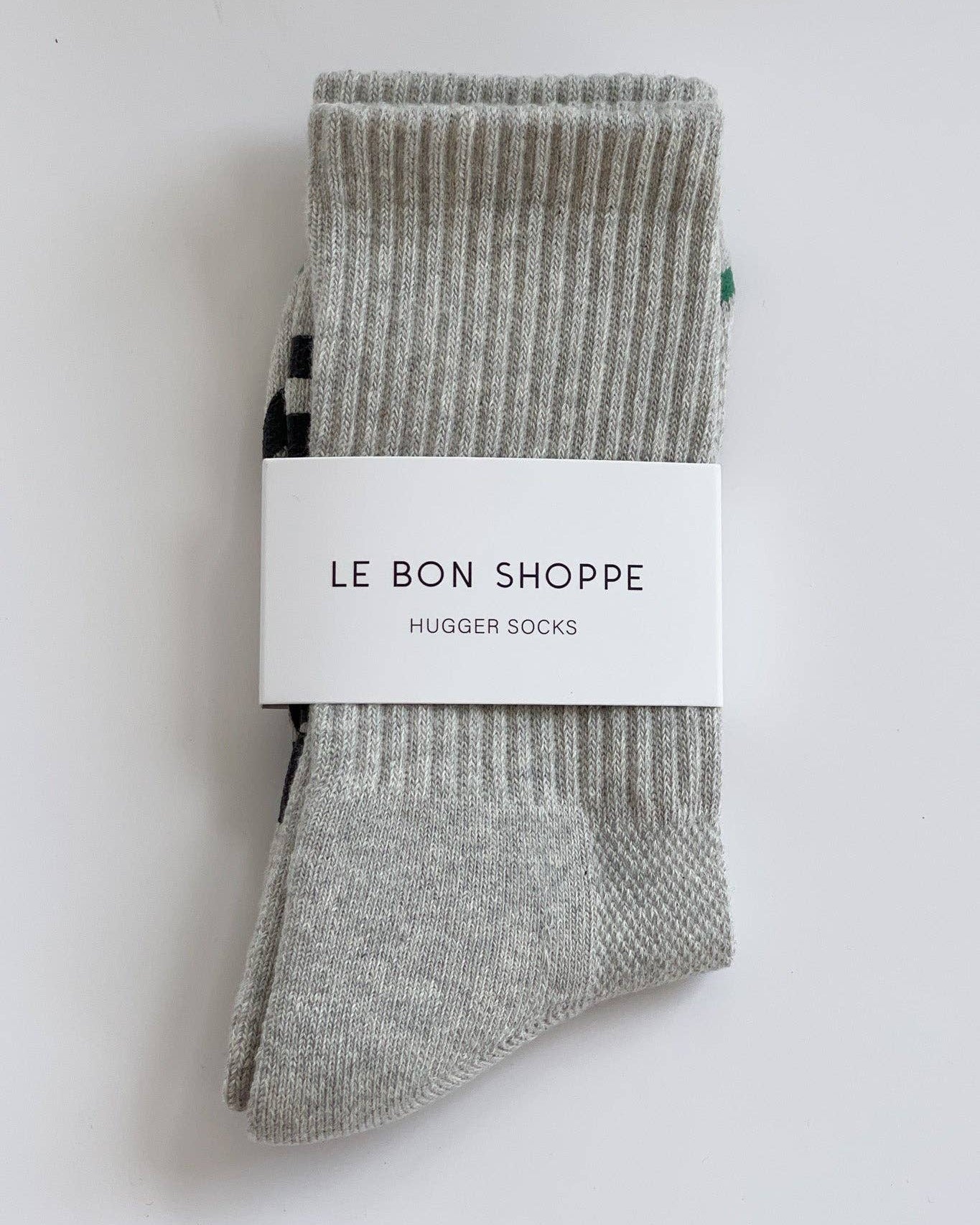 Packaged gray socks with 'Le Bon Shoppe' label on a white background