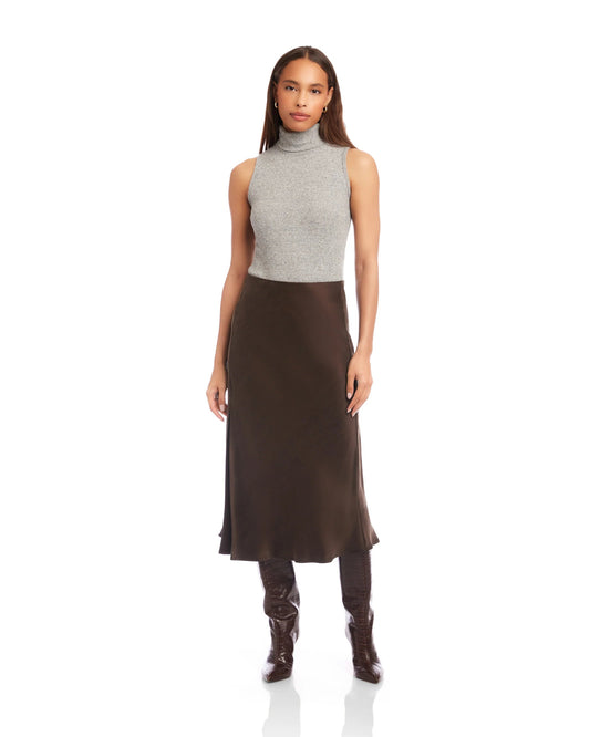 Model is wearing Fifteen Twenty Brielle Midi Skirt in color Brown on a white background. 