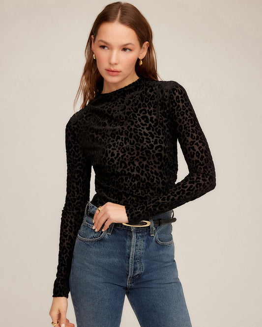 Model wearing Khami Velvet Burnout Shirred Top with jeans on a white background