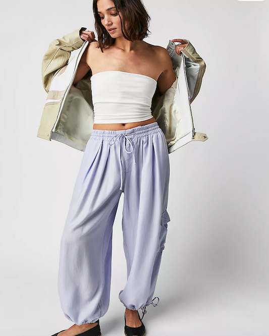 Model Wearing Free People Palash Cargo Solid Periwinkle Pants Wearing A White Tube Top On A White Background
